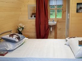 A bedroom with a bed and a sink at St Austell Glamping