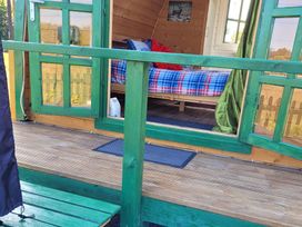 A bedroom with a bed and blanket at St Austell Glamping