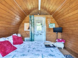 A bedroom with a bed and television at St Austell Glamping in St Austell