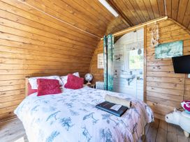 A bedroom with a bed and sink at St Austell Glamping in St Austell
