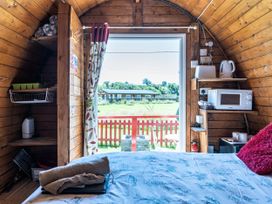 A cabin interior with kitchenette and bed at St Austell Glamping in St Austell