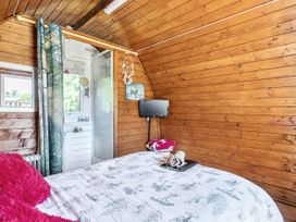 A bedroom with a bed and television at St Austell Glamping in St Austell