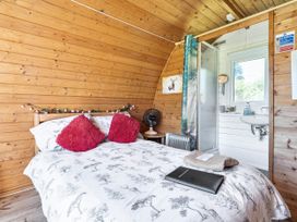 A bedroom with a bed and shower at St Austell Glamping in St Austell