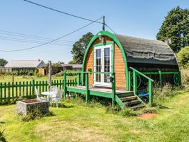 A cabin with a porch and seating area at St Austell Glamping in St Austell
