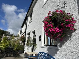 An outdoor area with a flower basket and seating at the property in 