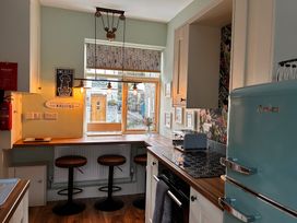 A kitchen with a bar area and modern appliances at The Old Barn in Manchester