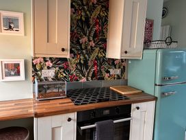A kitchen with a refrigerator and toaster at The Old Barn in Manchester