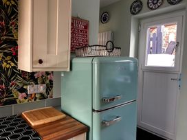 A kitchen with a refrigerator and cutting board at The Old Barn in Manchester