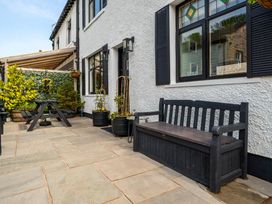 An outdoor seating area with a table and bench at 20 Main Street Heysham