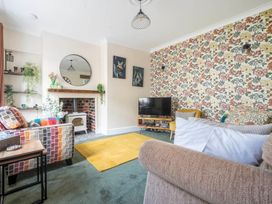 A living room with a fireplace and television at 20 Main Street Heysham