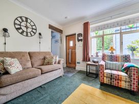 A living room with a sofa and armchair at 20 Main Street in Heysham