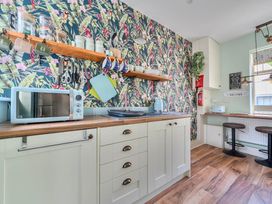 A kitchen with a sink and microwave at 20 Main Street in Heysham