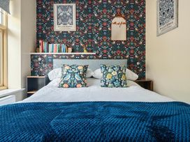 A bedroom with a bed and bookshelf at 20 Main Street in Heysham