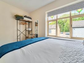 A bedroom with a bed and a shelf at 20 Main Street in Heysham