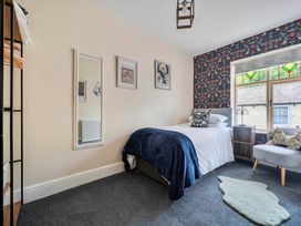 A bedroom with a bed and mirror at 20 Main Street Heysham