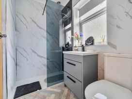 A bathroom with a shower, sink, and toilet at 20 Main Street Heysham