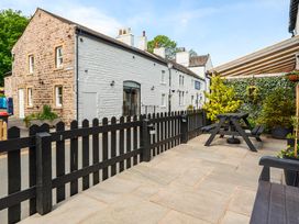 An outdoor area with a table and plants at 20 Main Street in Heysham