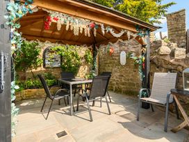 An outdoor dining area with table and chairs at 20 Main Street in Heysham