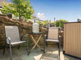 An outdoor space with two chairs and a table at 20 Main Street in Heysham