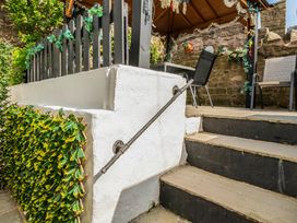 A staircase with a handrail leading to an outdoor area at 20 Main Street Heysham