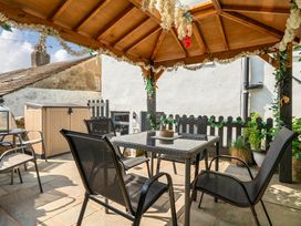 An outdoor seating area with a gazebo and table at 20 Main Street in Heysham