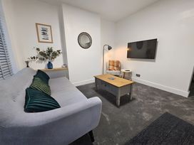 A living room with a sofa and coffee table at 140 Finchley Road