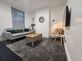A living room with a sofa and coffee table at 140 Finchley Road