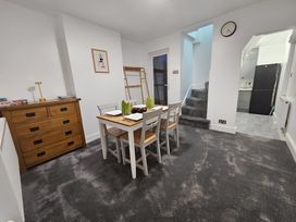 A dining room with a table and chairs at 140 Finchley Road