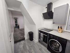 A kitchen with a stove and washing machine at 140 Finchley Road