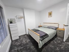 A bedroom with a bed and bedside table at 140 Finchley Road