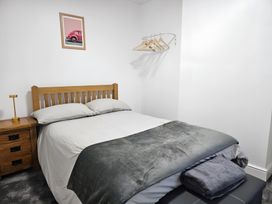 A bedroom with a bed and nightstand at 140 Finchley Road