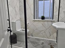 A bathroom with a toilet and sink at 140 Finchley Road