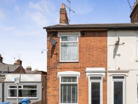A side view of a house with windows and satellite dish at 140 Finchley Road in Ipswich