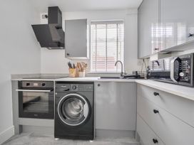 A kitchen with appliances and cabinets at 140 Finchley Road Ipswich