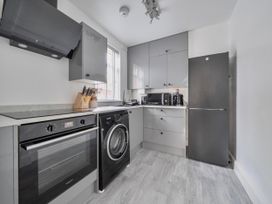 A kitchen with appliances and cabinets at 140 Finchley Road Ipswich