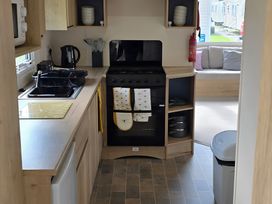 A kitchen with a sink and stove at Caravan 