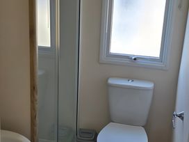 A bathroom with a toilet and shower at Caravan