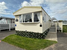 A mobile home with windows and steps at a holiday park in location