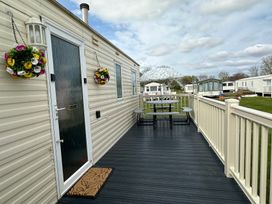 An outdoor area with seating and decorative plants at a vacation home