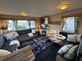 A living room with a sofa and dining table at the property