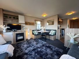 A living room with a television and dining table at the property in the unspecified location