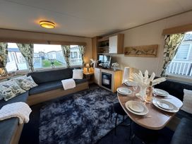 A living room with a table and sofa at the property