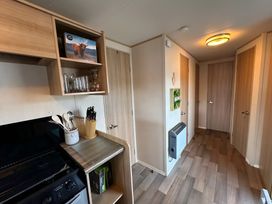 A kitchen with cupboards and utensils at the property in location