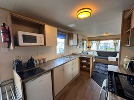 A kitchen with a microwave and kettle at the property in the location