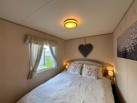 A bedroom with a bed and window at a property in an unknown location