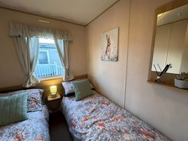 A bedroom with two beds and a window at 