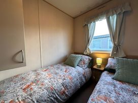 A bedroom with two beds and a lamp at the property in location