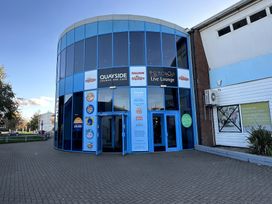 A restaurant entrance with blue windows and signage at Quayside in Southport