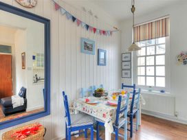 A dining room with a table and chairs at 1 The Old Posthouse Lyme Regis