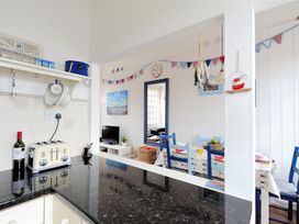 A kitchen with a toaster and wine bottle at 1 The Old Posthouse in Lyme Regis